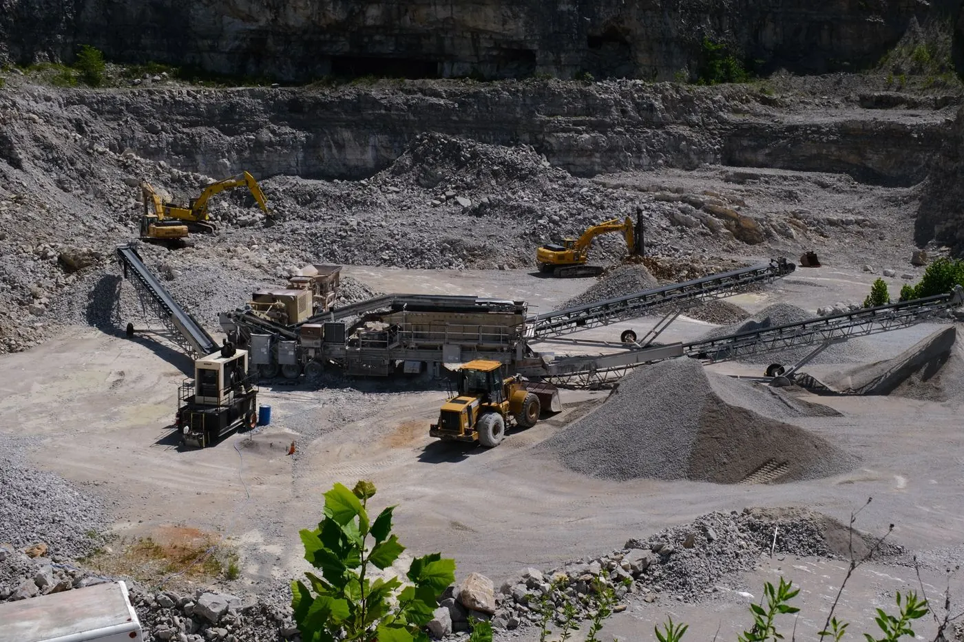 Local quarry with crusher, conveyors and loader producing crushed stone